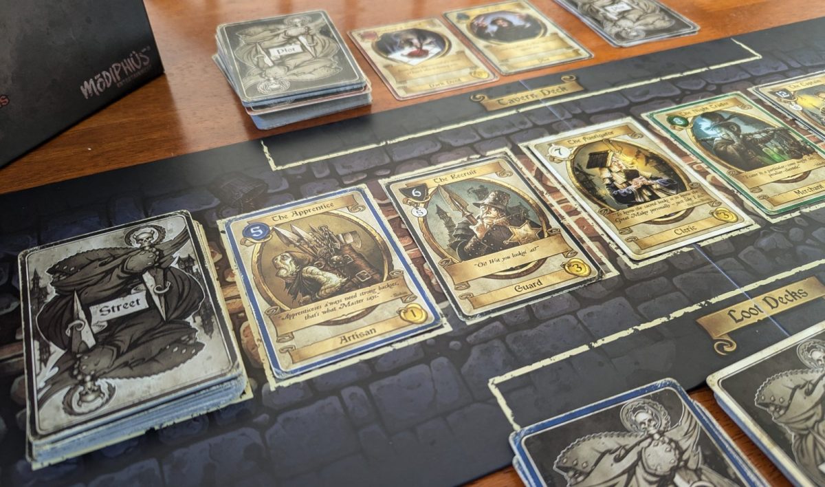 Dark Deeds cards lined up on a black tabletop playing field.